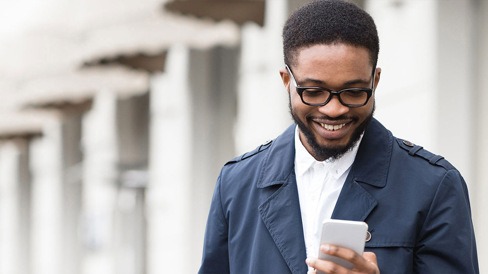 man looking at phone and smiling