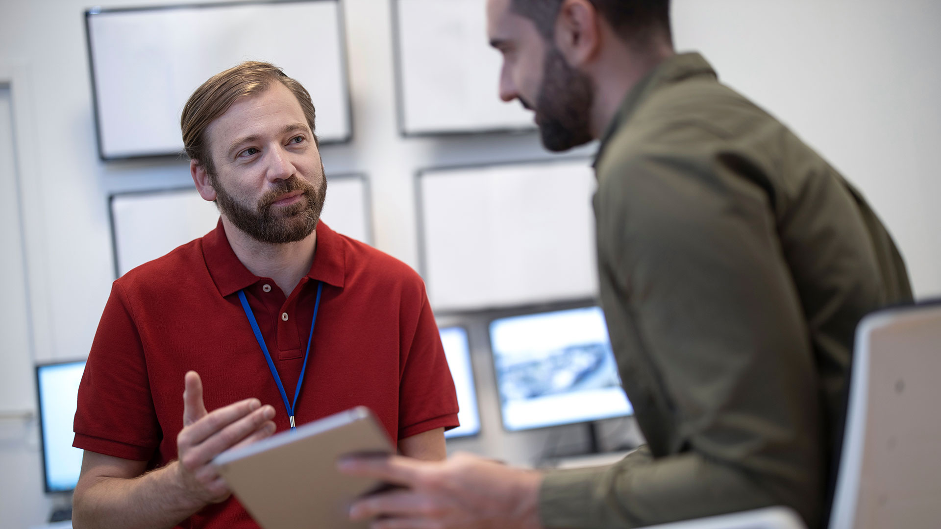 Two men sat at a laptop computer