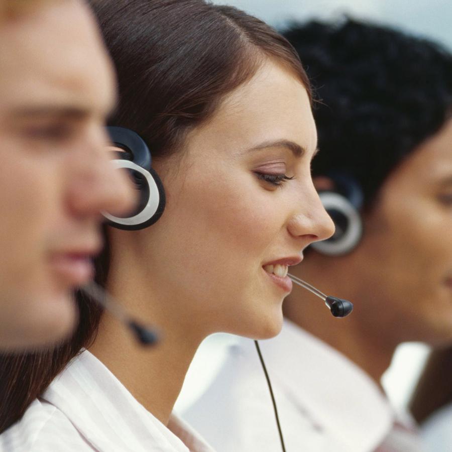 A woman with a headset speaking to customers