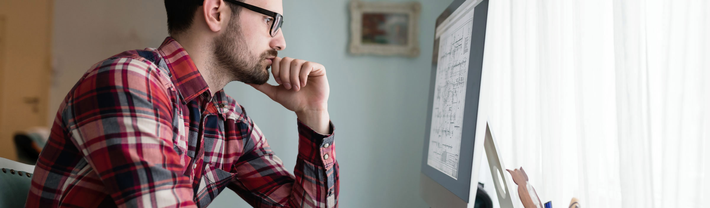 Man concentrating on a computer screen