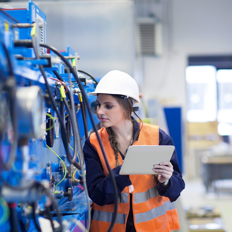 Girl inspecting the machine with tablet