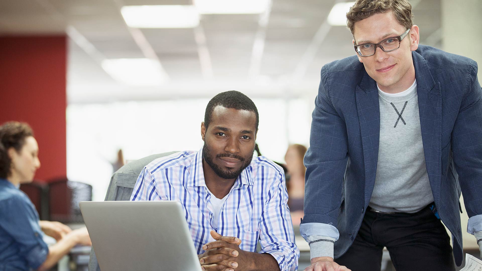 Two people smiling in office