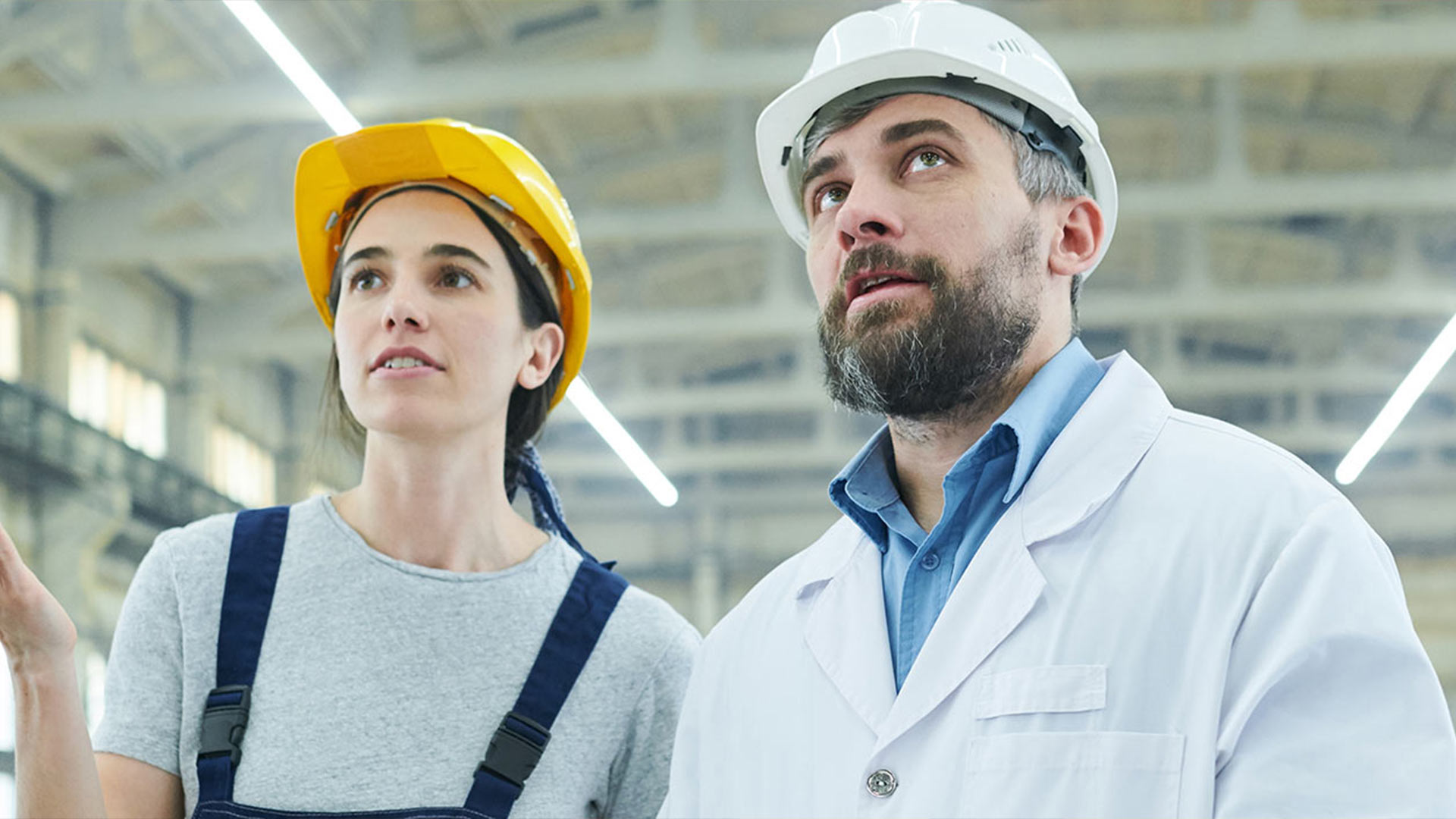 a man and woman wearing hardhats