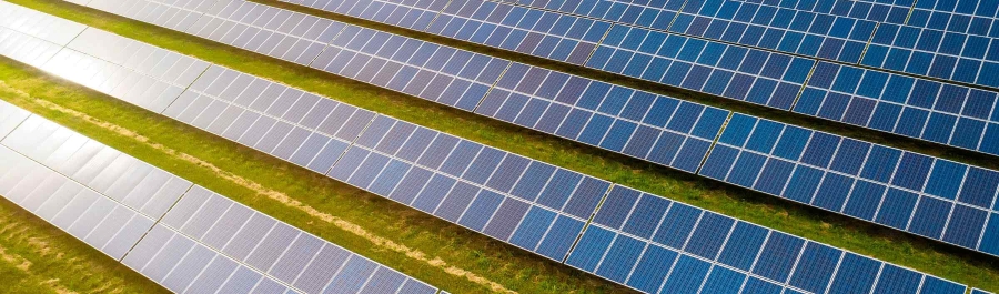 A solar panel array in a green field