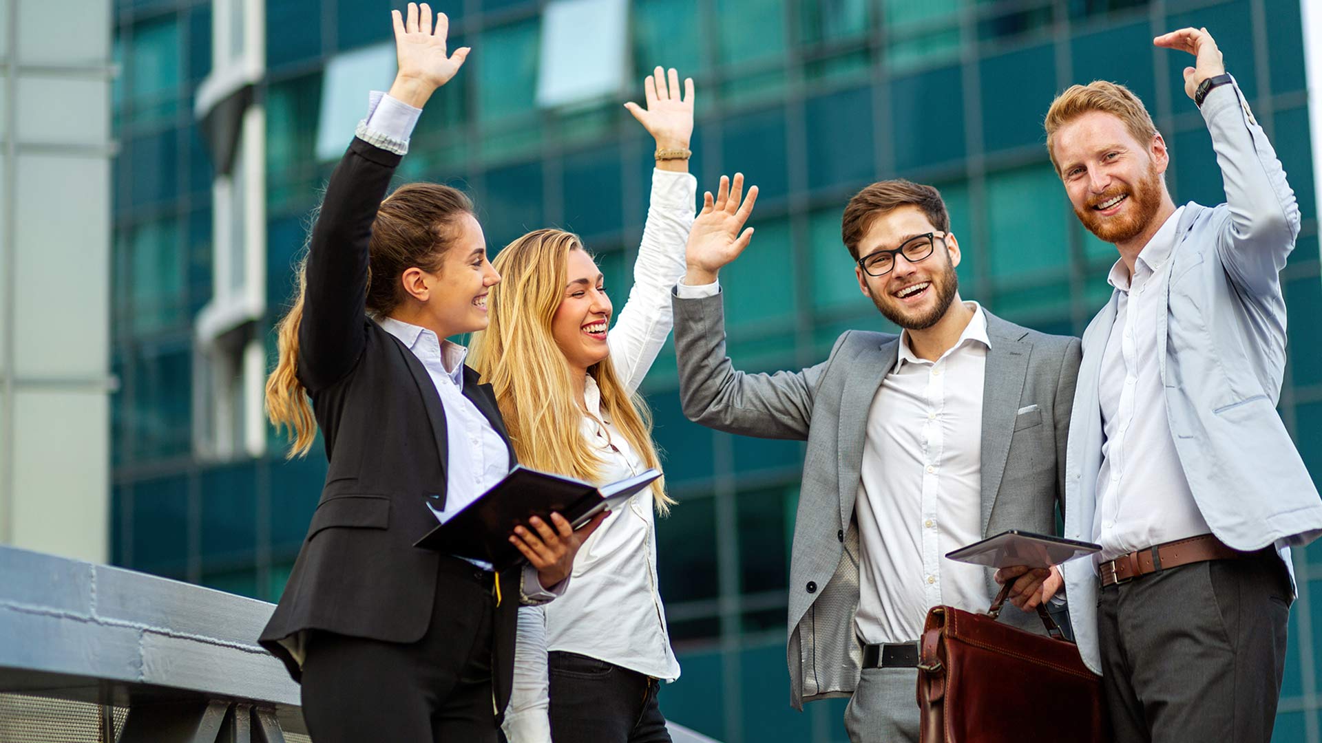 Employees cheering outside their office
