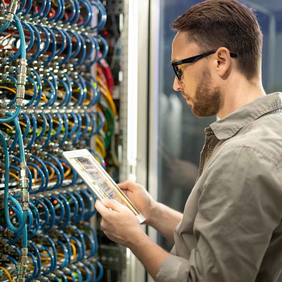 Data center engineer checking on equipment