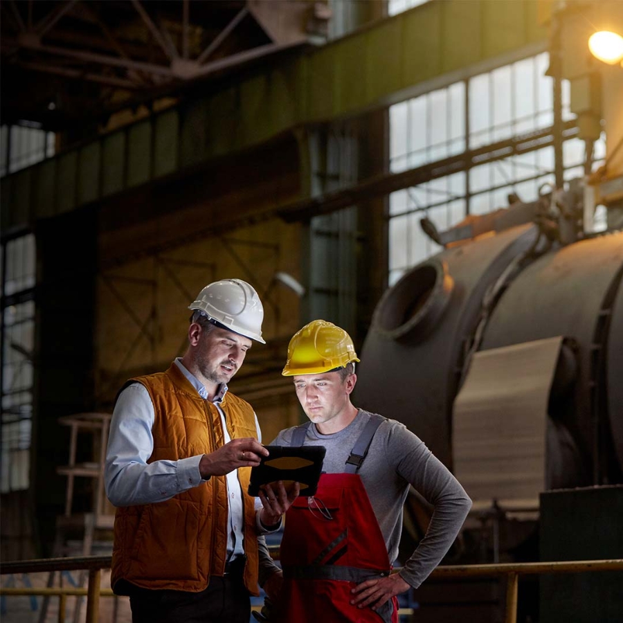 Two engineers discussing inside a factory