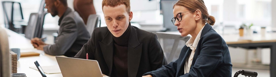 Individuals looking at a laptop